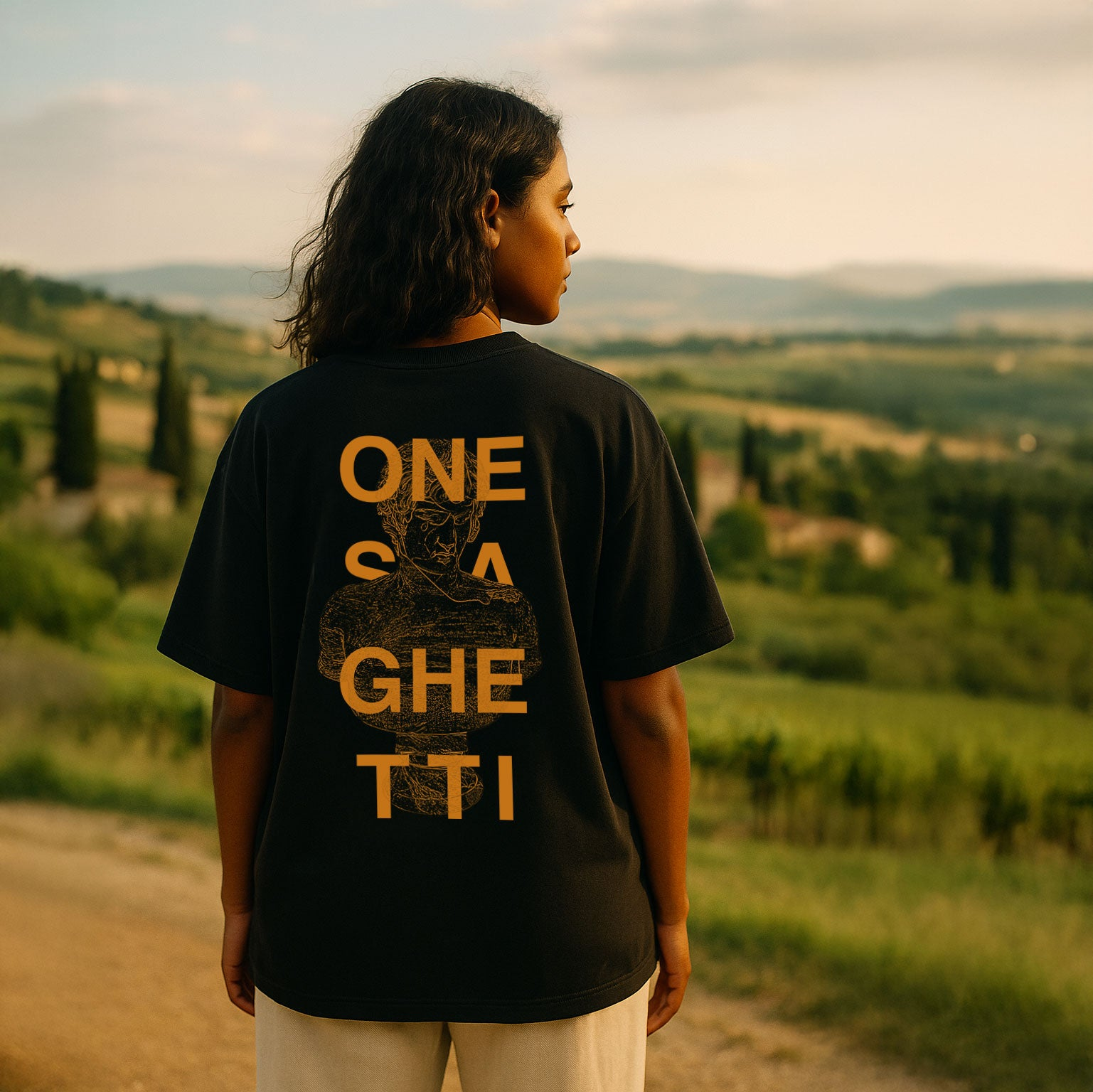 Woman wearing oversized black One Spaghetti Monument Series T-shirt with back print, limited edition streetwear in Italy.